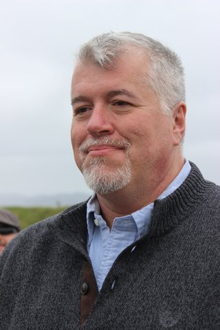 Jonathan in a gray sweater on the wedding day.